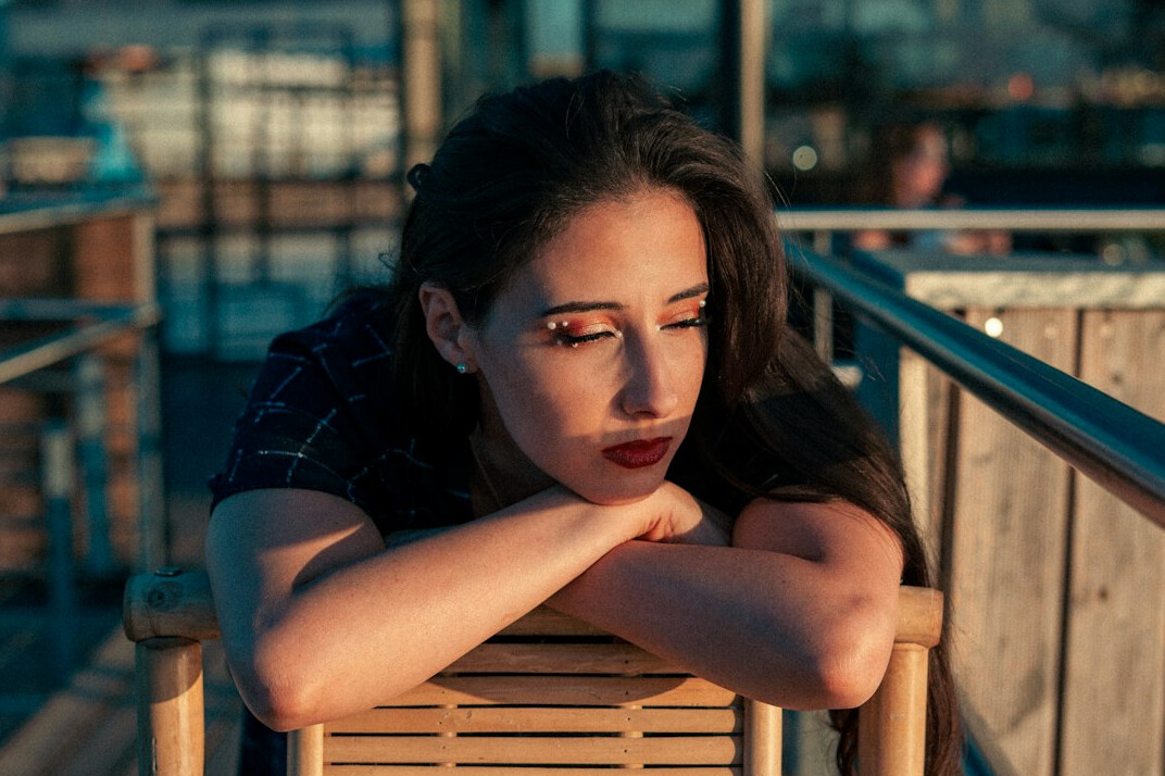 Calm woman with dark hair looking at the camera