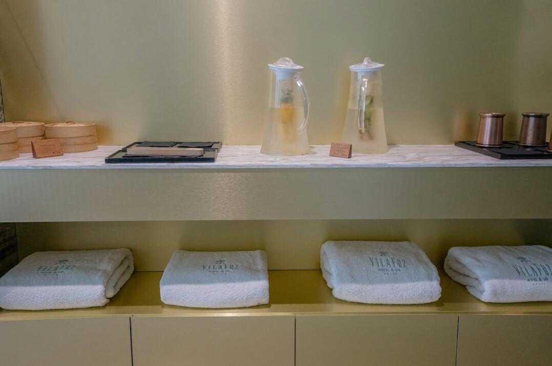 Spa stones, towels and candles arranged for a body treatment